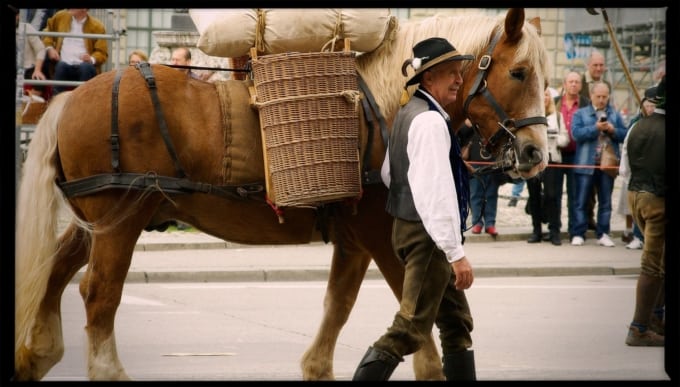 Horse with guide carrying sacks and baskets